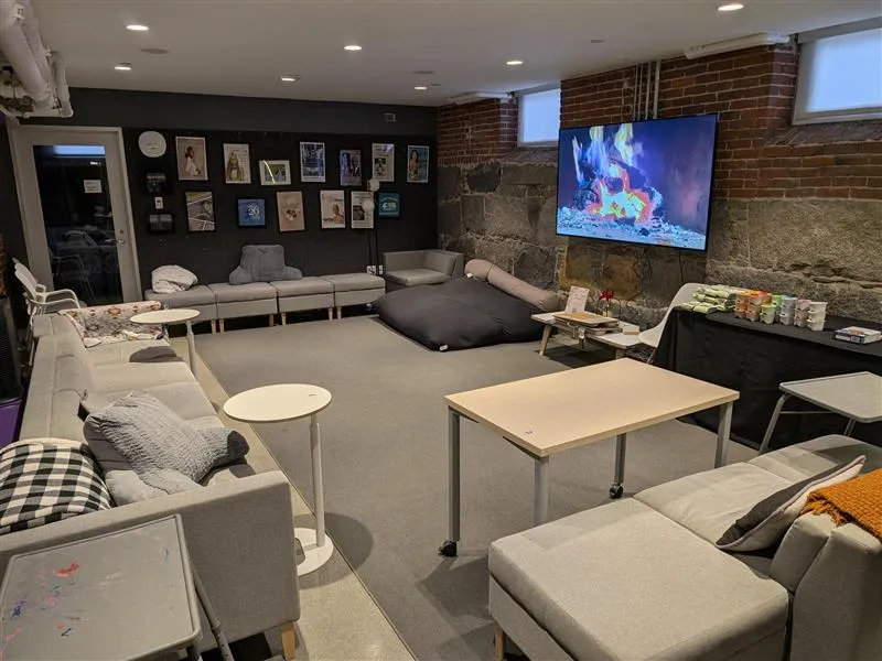 A study space at the Harvard Foundation, featuring many chairs and tables spread throughout the room.