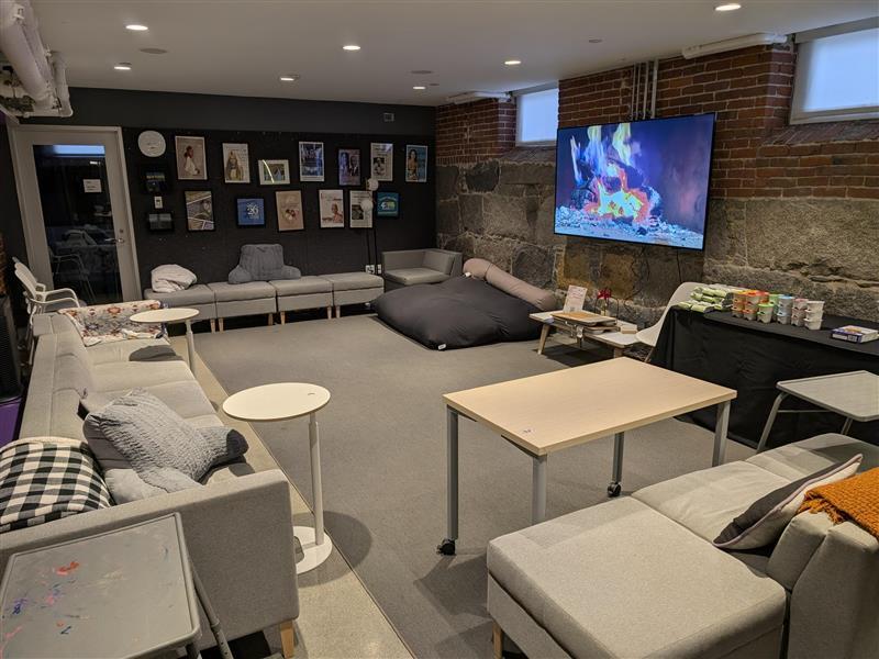A study space at the Harvard Foundation, featuring many chairs and tables spread throughout the room.
