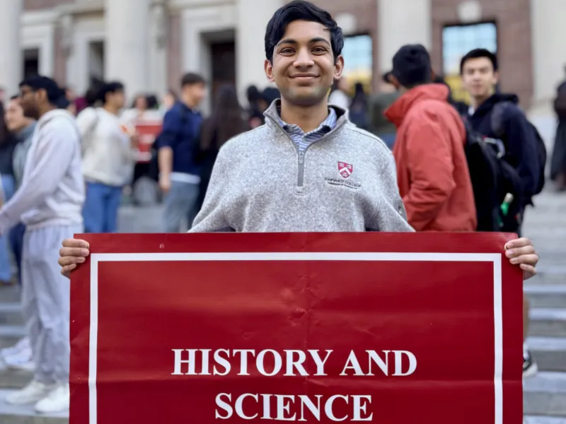 I pose with the sign for History and Science in front of Widener Library