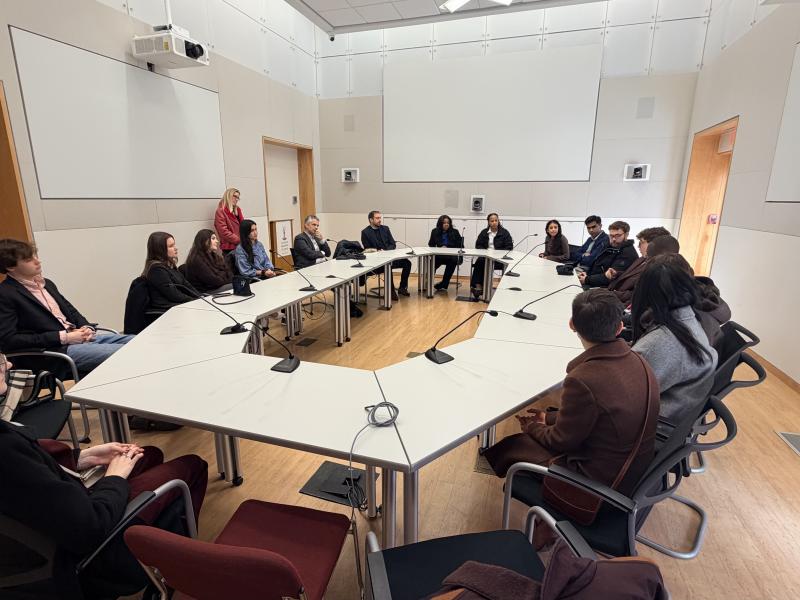 Students sitting around a table during orientation. 