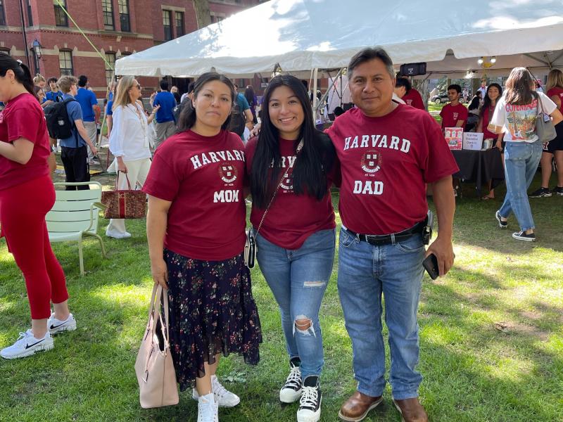 Three people smiling at the camera. 