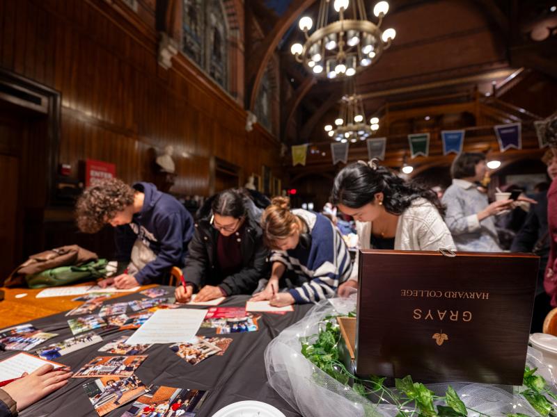 Students writing letters for their dorm-specific time capsules.