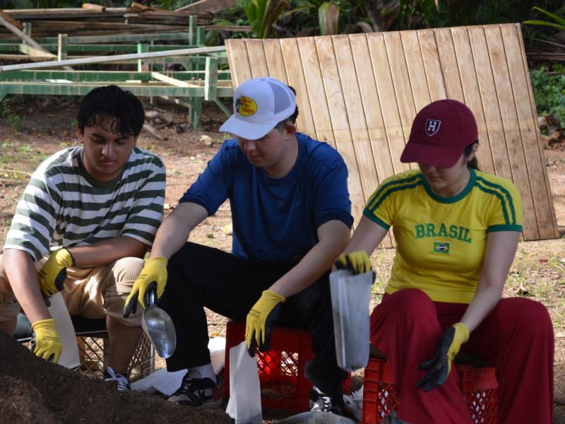 Bishwo Jeet ‘29, James Miller ‘29 and Maria Clara Souza Rocha ‘29  packing nursery bags.
