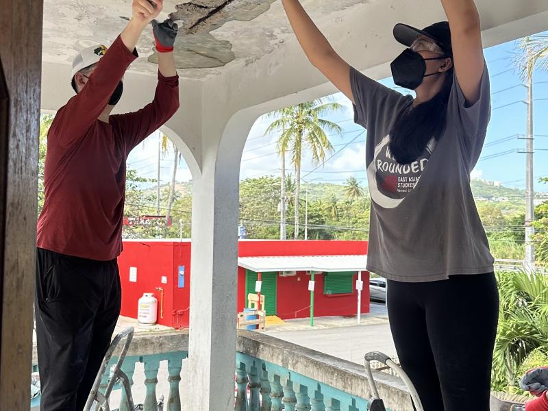 James Miller ‘29 and Diya Patel ‘29 preparing the ceiling of a local community member’s home for repair and resurfacing.