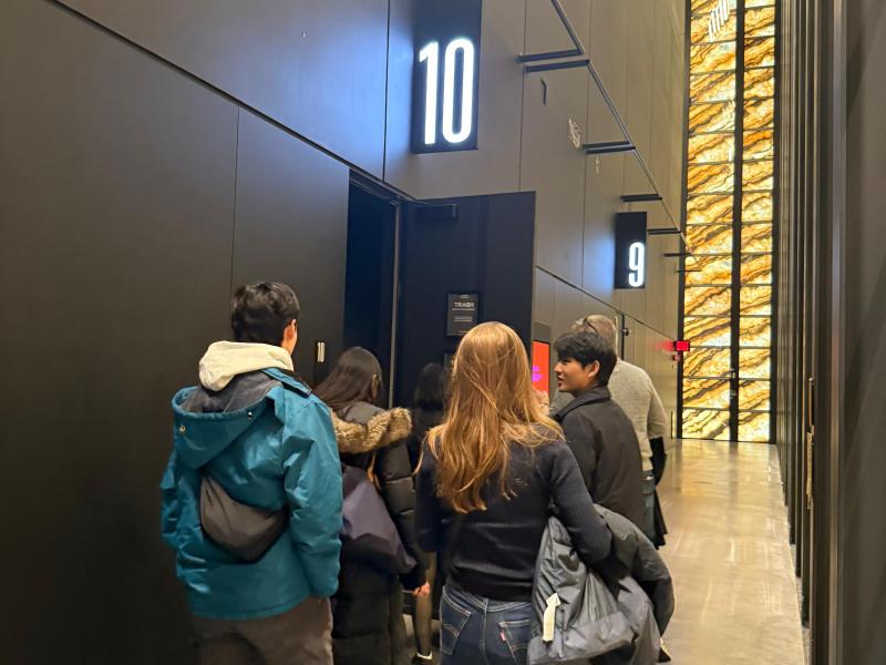 Students walking behind stage door 10 inside the Perelman Performing Arts Center.