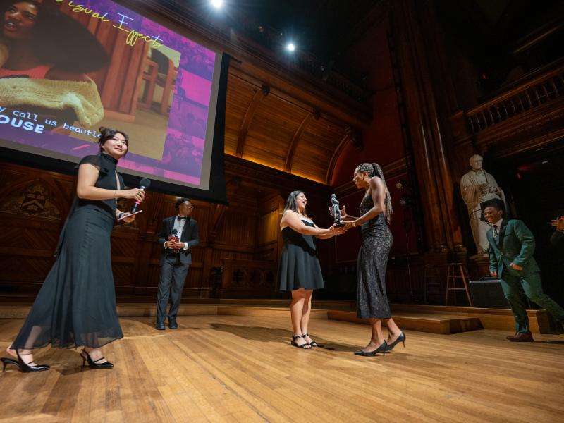 A student from Currier House onstage accepted the award for Best Editing & Visual Effects.