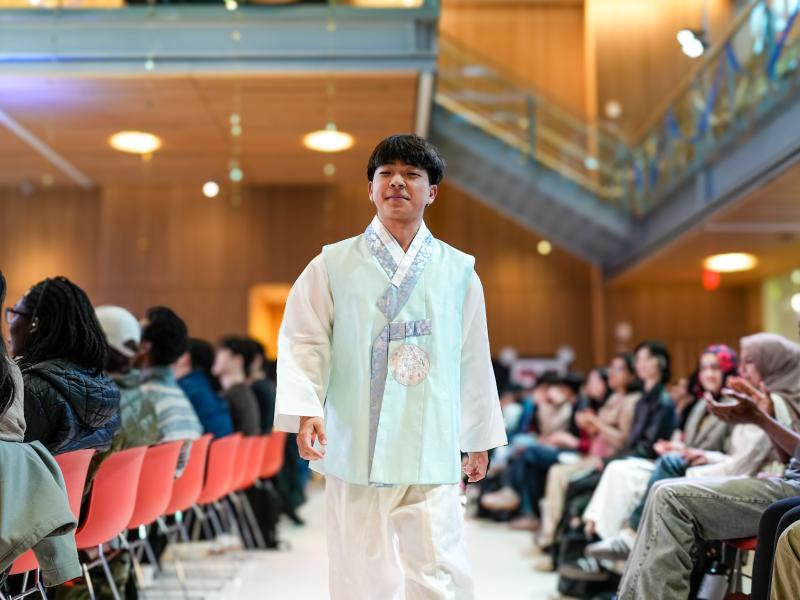 Chanho Lee ‘29 walking the runway at the Cultural Rhythms Fashion Showin a hanbok, commonly worn during Korean holidays.