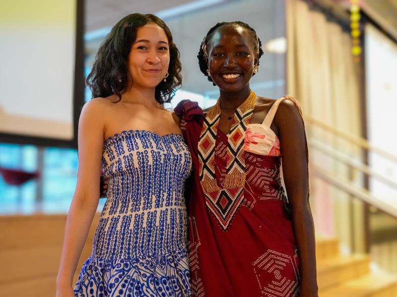 Caitlyn Gonzalez ‘28 (left) showcasing her Vestido De Flores dress from Mexico and Elizabeth Mou ‘28 (right) showcasing her Lawa from South Sudan at the Cultural Rhythms Fashion Show. 