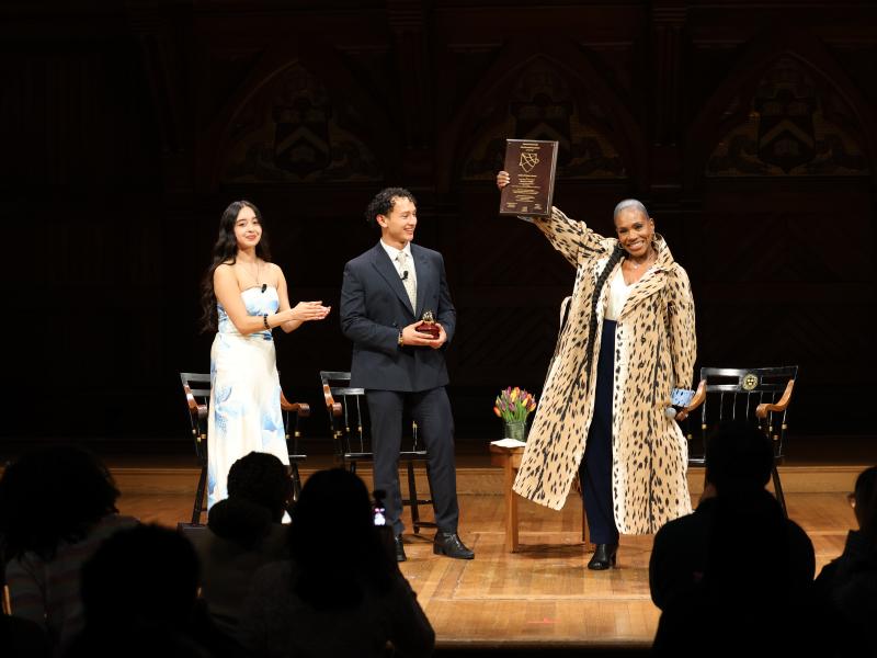 Cultural Rhythms Co-Coordinators Amber Nolazco-Torres ‘26  and Jason Coreas ‘27 applauding Cultural Impact Award Honoree Sheryl Lee Ralph while she is holding up her plaque at the 40th Annual Cultural Rhythms Show. 