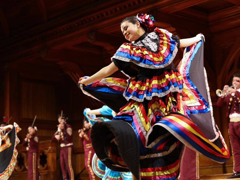 A dancer from Harvard RAZA Ballet Folklorico performing  at the 40th Annual Cultural Rhythms Show while Undergraduate Mariachi Veritas de Harvard performs in the background. 