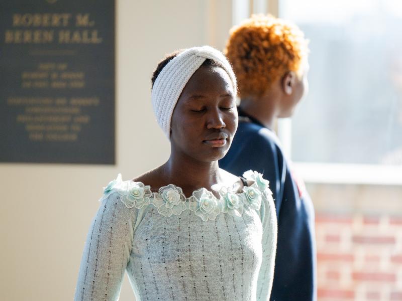 Closeup of student with their eyes closed.