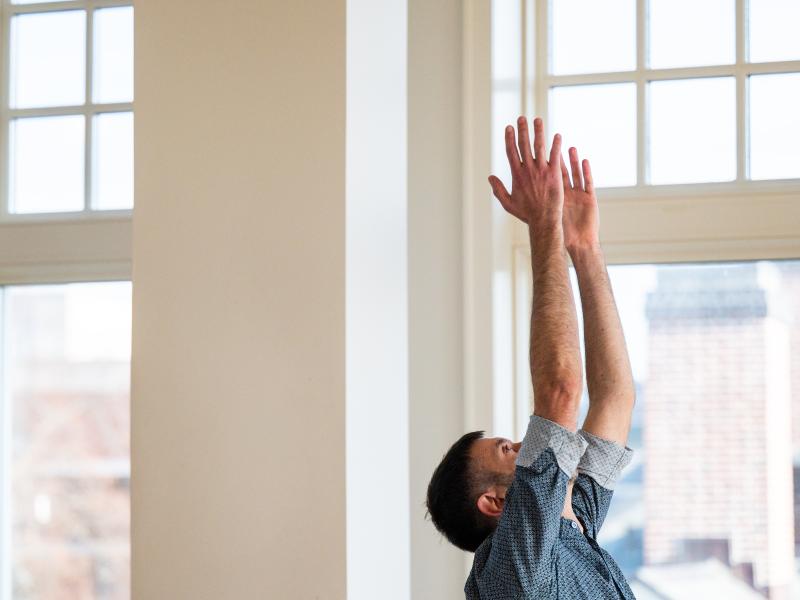 Mauro Morabito with his hands outstretched and reaching up. 