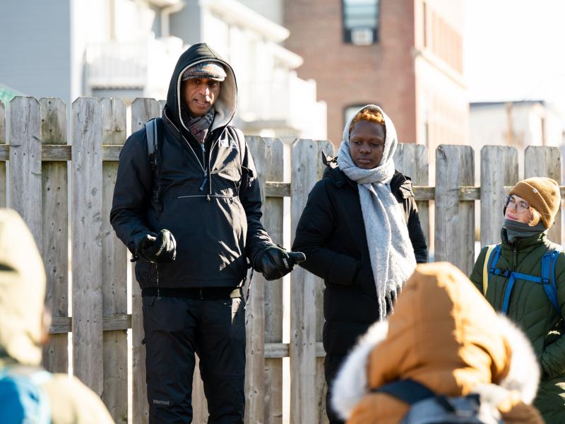 Eastie Farm Director Kannan Thiruvengadam standing in front of the group and talking.