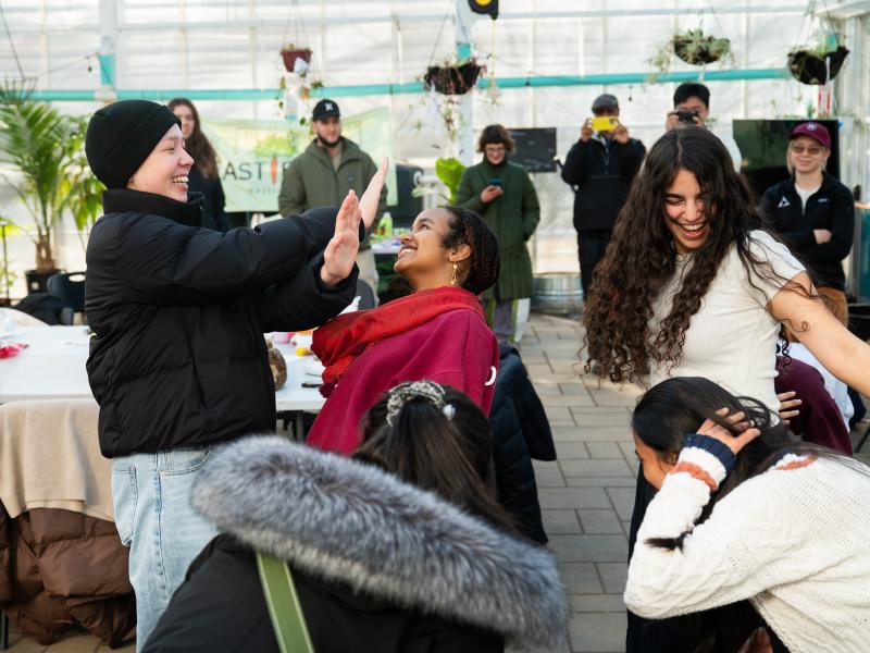 Student laughing in a circle while doing embodiment exercises at Eastie Farm.