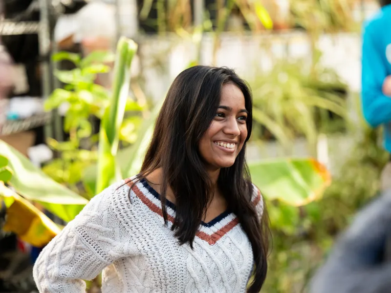 A closeup of a student smiling at Eastie Farm.
