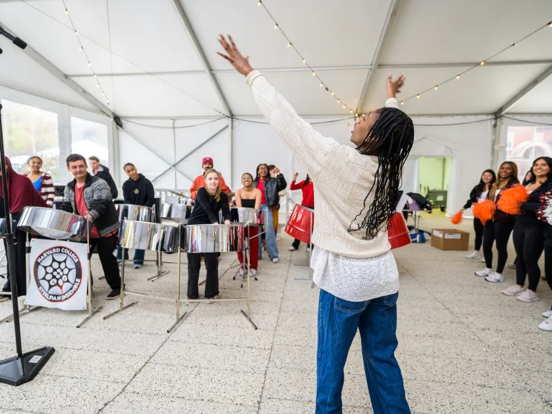 The Harvard College Steelpan Ensemble (left) and Harvard Cheer and Crimson Dance Teams (right).