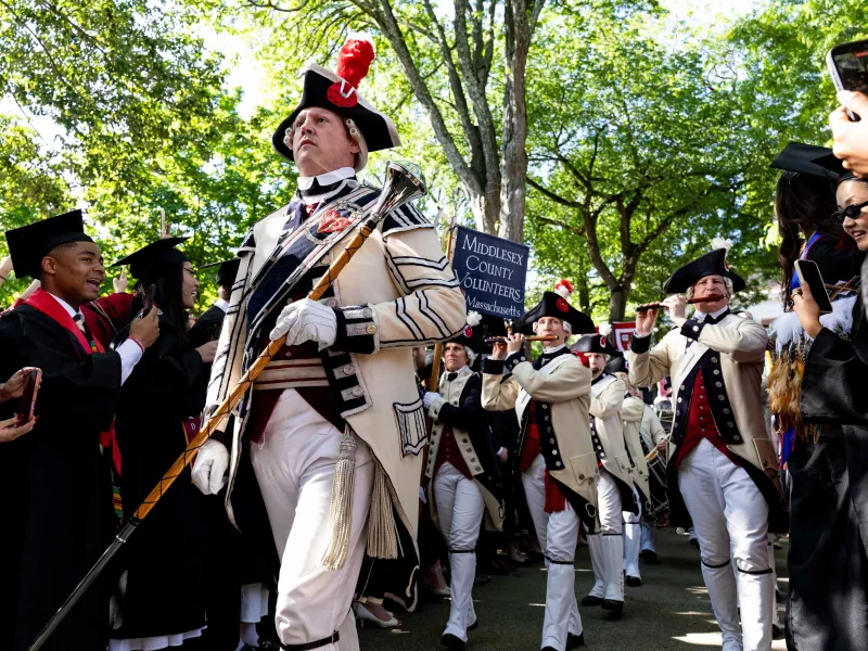 The Middlesex County Volunteers Fifes & Drums leading the group with flutes and drums while dressed in period clothing.