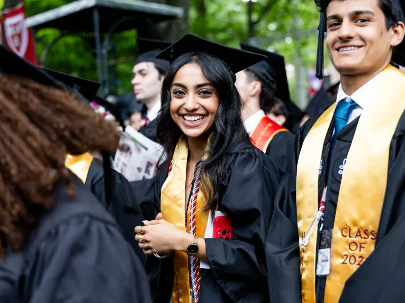 Closeup of one male and one female graduate smiling.