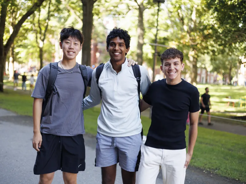 Three first year students standing next to each other and smiling.