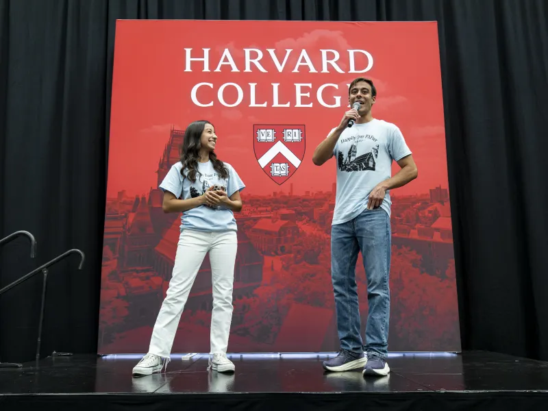 Student Megan Martinez '28 (left) and a male student (right) speaking onstage to represent the PAFs.
