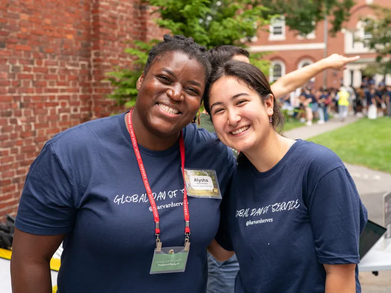Resident Dean of Elm Yard, Alysha Johnson Williams, smiling with a young female participant.