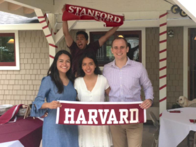 Students holding Harvard flag