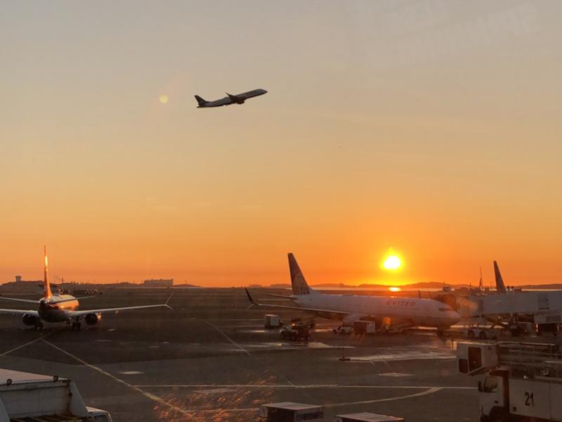 Image of plan taking off during the sunrise. 