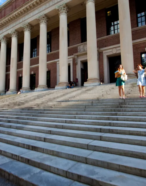 Two students walking down the steps of Widener Library