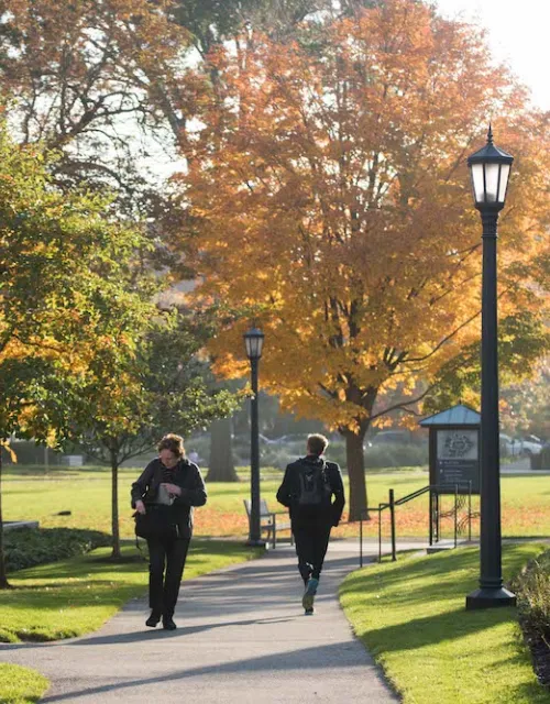 students walking on campus in the fall