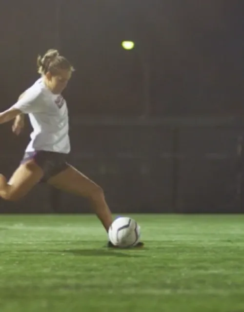 A student preparing to kick a soccer ball