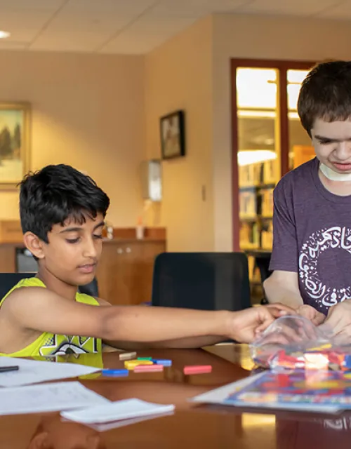 Ben Elwy '23 (right) is teaching Arabic and cultural education to children at the Wellesley Free Library. 