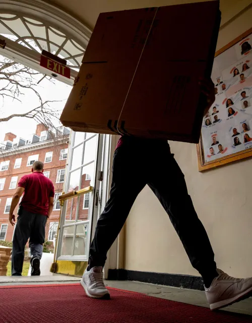 Packing boxes move in as students pack up to move out of Eliot House.