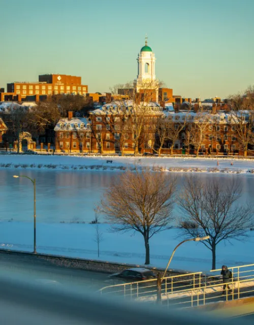 A view of the Charles River and Leverett House during the winter season.