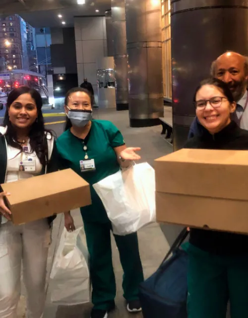 Luca Di Pietro (left) makes the first meal delivery from Feed the Frontlines NYC to the NYU Langone Medical Center's Emergency Department.