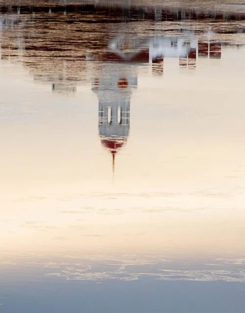 A reflection of Harvard's campus on the Charles River.