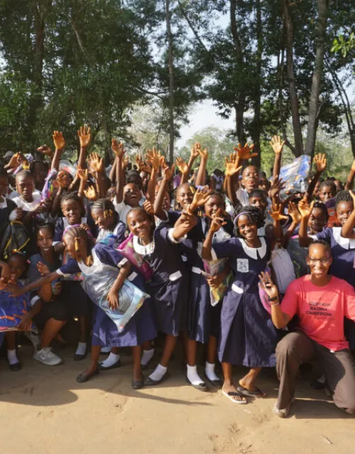 This past December, twins Suuba (far left) and Sadia Demby (far right) donated 480 backpacks and three laptops to their father’s ancestral village, Gerihun, in Sierra Leone.