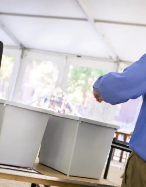 man shown dropping off a covid-19 test