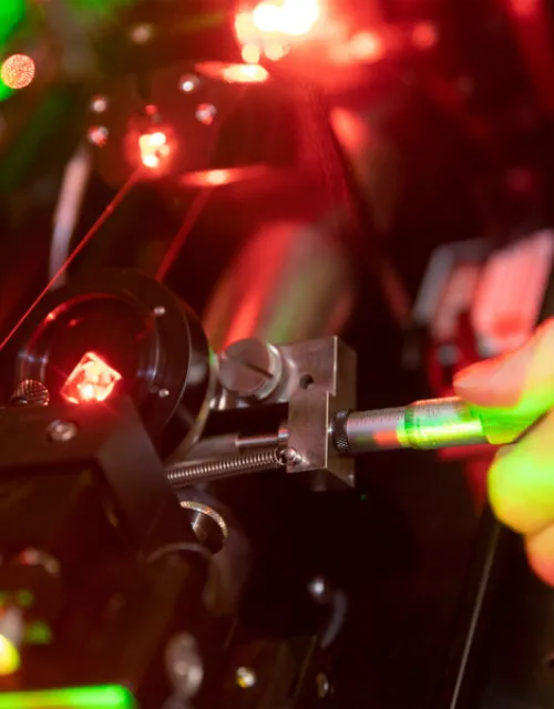 Working with lasers in the Doyle Lab.