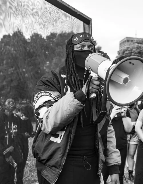 A protester in Boston was photographed by OJ Slaughter. Slaughter was one of 12 artists awarded one-time honorariums by the Harvard University Committee on the Arts.