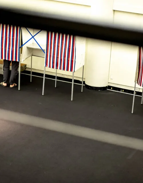 Individuals voting at the polls.
