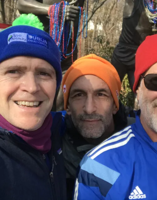 Taking a break during a Sunday run last February, Bob Manson, M.P.A. ’04, (left) poses with Daniel Lieberman ’86 (right) and a fellow runner in Newton at Heartbreak Hill, along the Boston Marathon course.