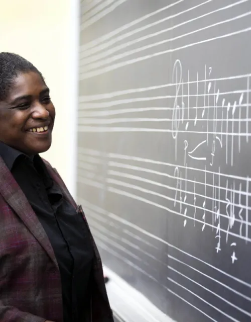Yvette J. Jackson, the Assistant Professor, Department of Music, stands in her classroom.