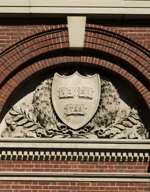 The Veritas emblem in a Harvard archway.