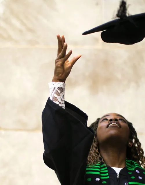 2021 graduate Nina Uzoigwe throws her cap.
