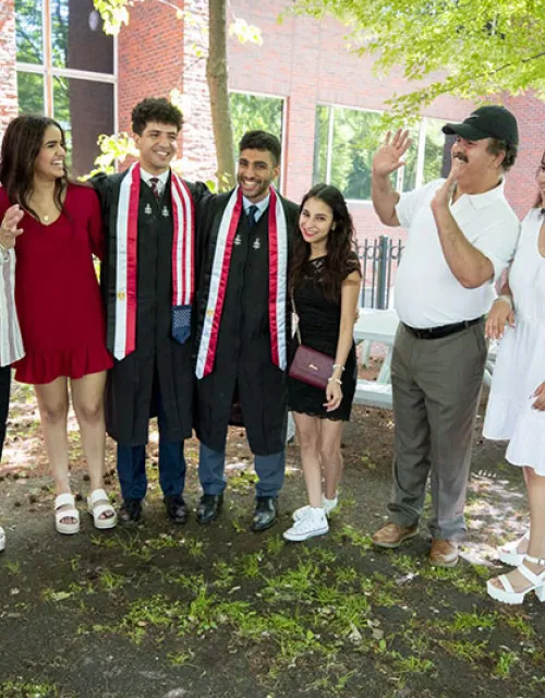 The families of Harvard friends Abdelaziz “Zizo” Nasr Bahnasy ’21 (center, left) of Currier House and Hassam Nasr Mabed ’21 (center, right) of Winthrop House meet on campus.