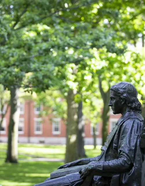 John Harvard watching over Harvard yard