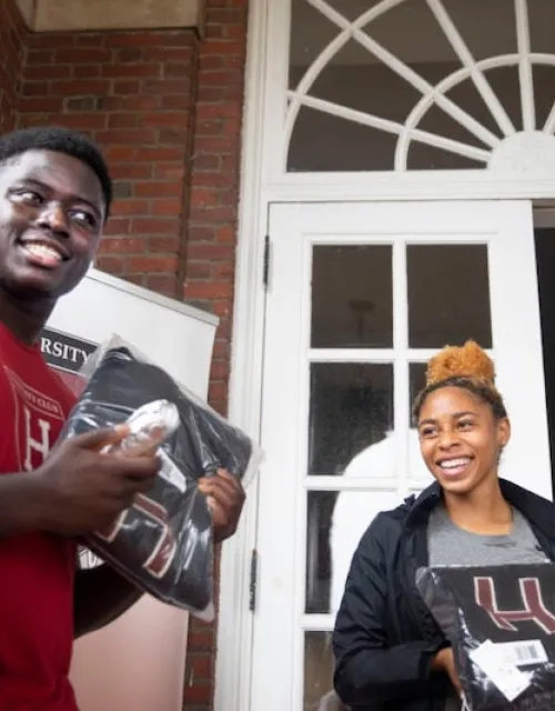 Football player Kwaku Adubofour ’24 and DaLoria Boone ’22 of women's track and field receive their "Major H" varsity letter sweaters at the first distribution day since 2019.