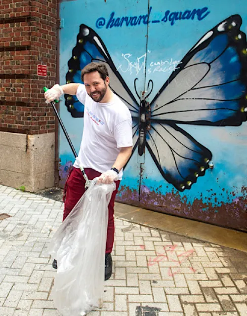 Team leader Kody Christiansen '23 cleans up Palmer Street behind the Coop in Harvard Square.