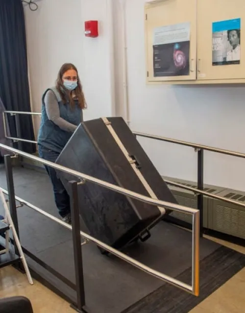 Astronomy Lab manager Allyson Bieryla wheels a portable telescope case on the ramp at the Science Center.
