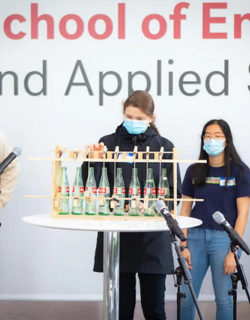 From left, Kwaku Adubofour (‘24), Victoria Levy (‘25), Sophia Liang (‘23) and Christian Rodriguez (‘23) present their instrument at the end-of-semester Symphosium concert on Dec. 6 in the Science and Engineering Complex Atrium in Allston.